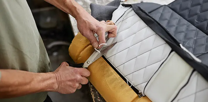Man Cutting Fabric for Sofa Repair Edmonton Upholstery Project
